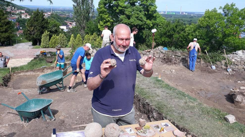 Lead archaeologist Nikolay Ovcharov showing off cannonballs and other artifacts.